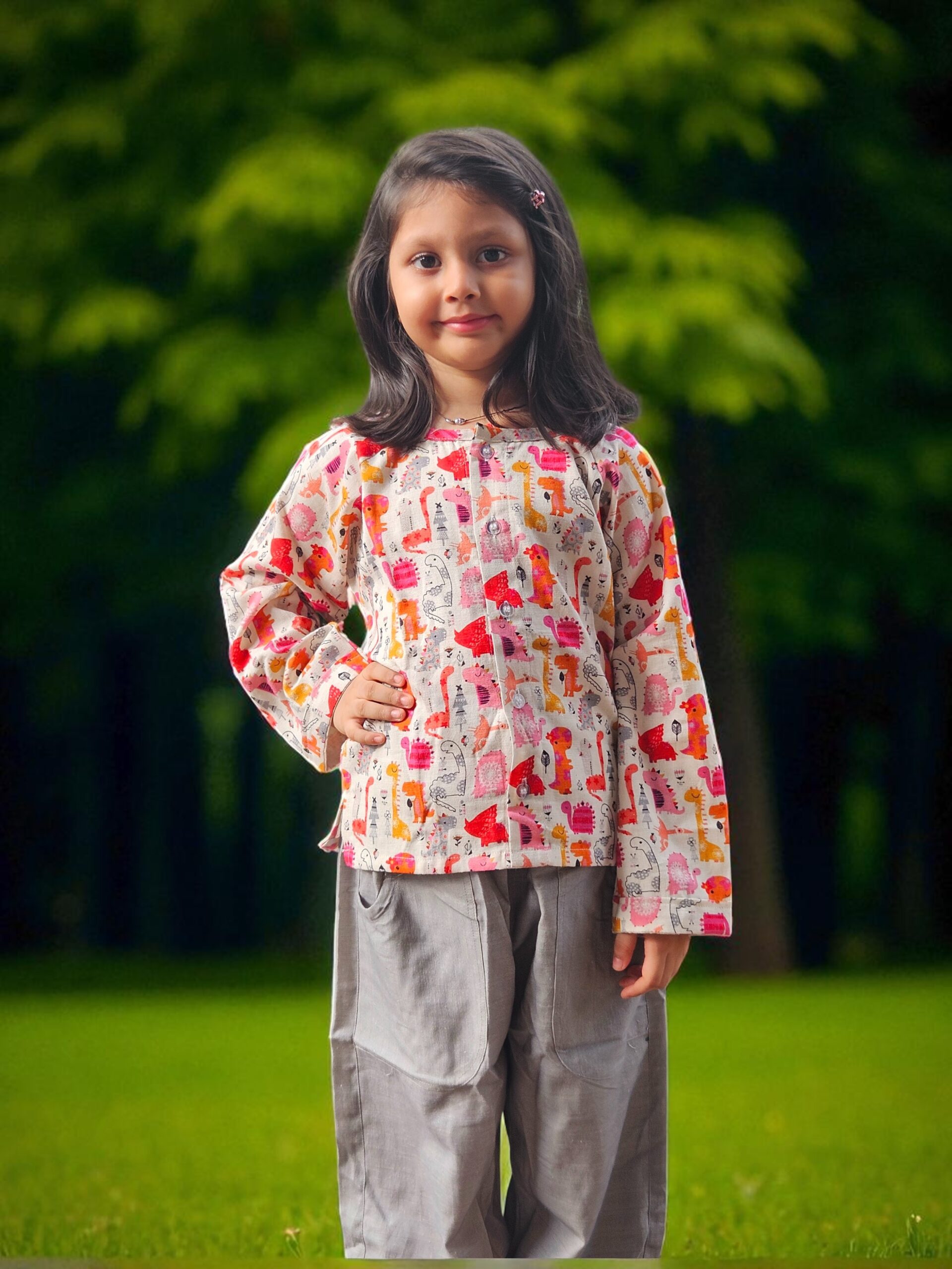 kidswear linen gender neutral co-ord set button-down shirt with digital printed pink and orange dinosaurs on white, paired with grey comfort fit joggers with two pockets, Luxury kidswear India