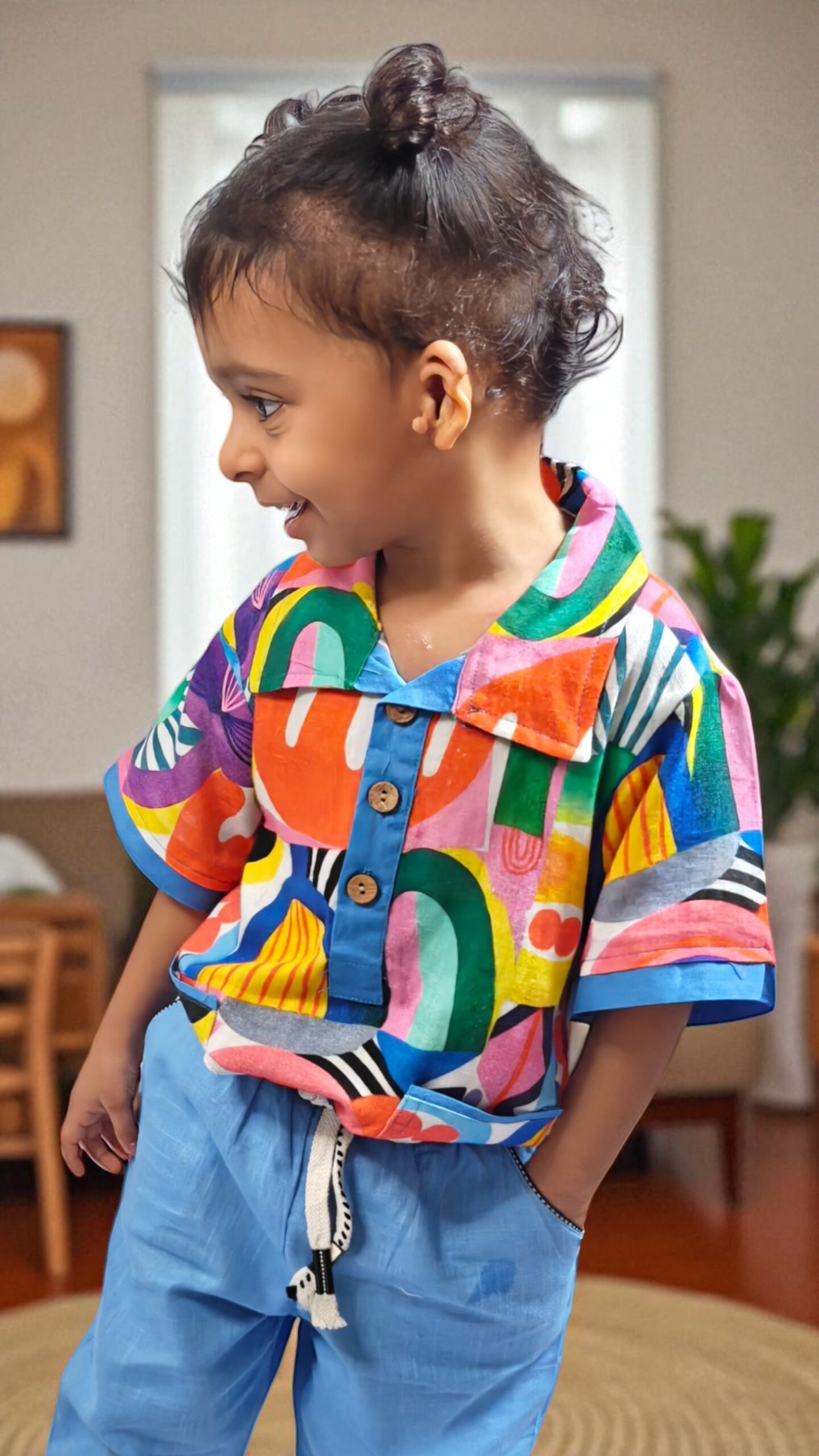 kidswear linen gender neutral half button down shirt with 3 button closure, two side pockets, digital printed abstract print in bright orange, yellow, blue green ages 1 to 7, Luxe kidswear India