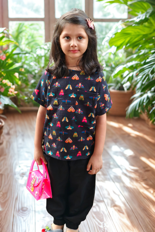 kidswear linen gender neutral co-ord set black top with one pocket, digital printed colourful moth print with black linen joggers, ages 1 to 7